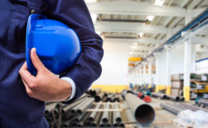 Worker holding his helmet